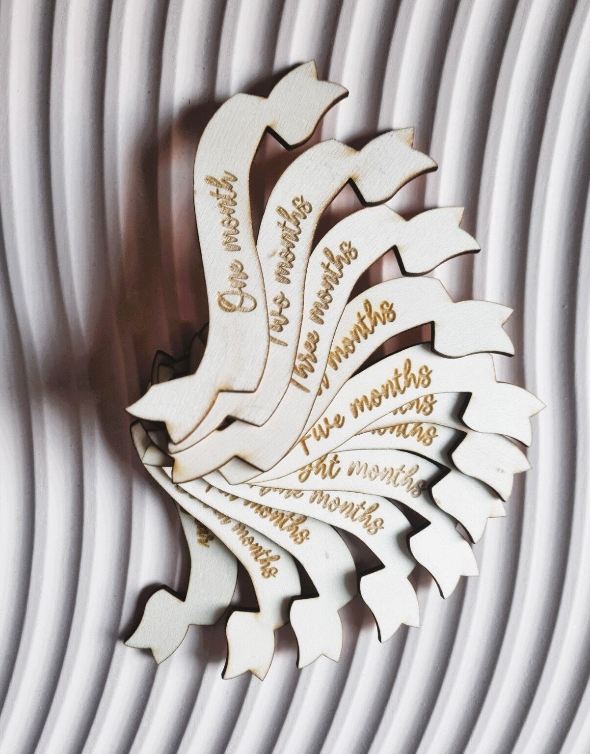 Baby Milestone photo prop set. The main piece is cut in the shape of a hot air balloon and each monthly milestone is engraved on a ribbon shaped piece of wood  that is interchangeable  in the centre of the balloon.