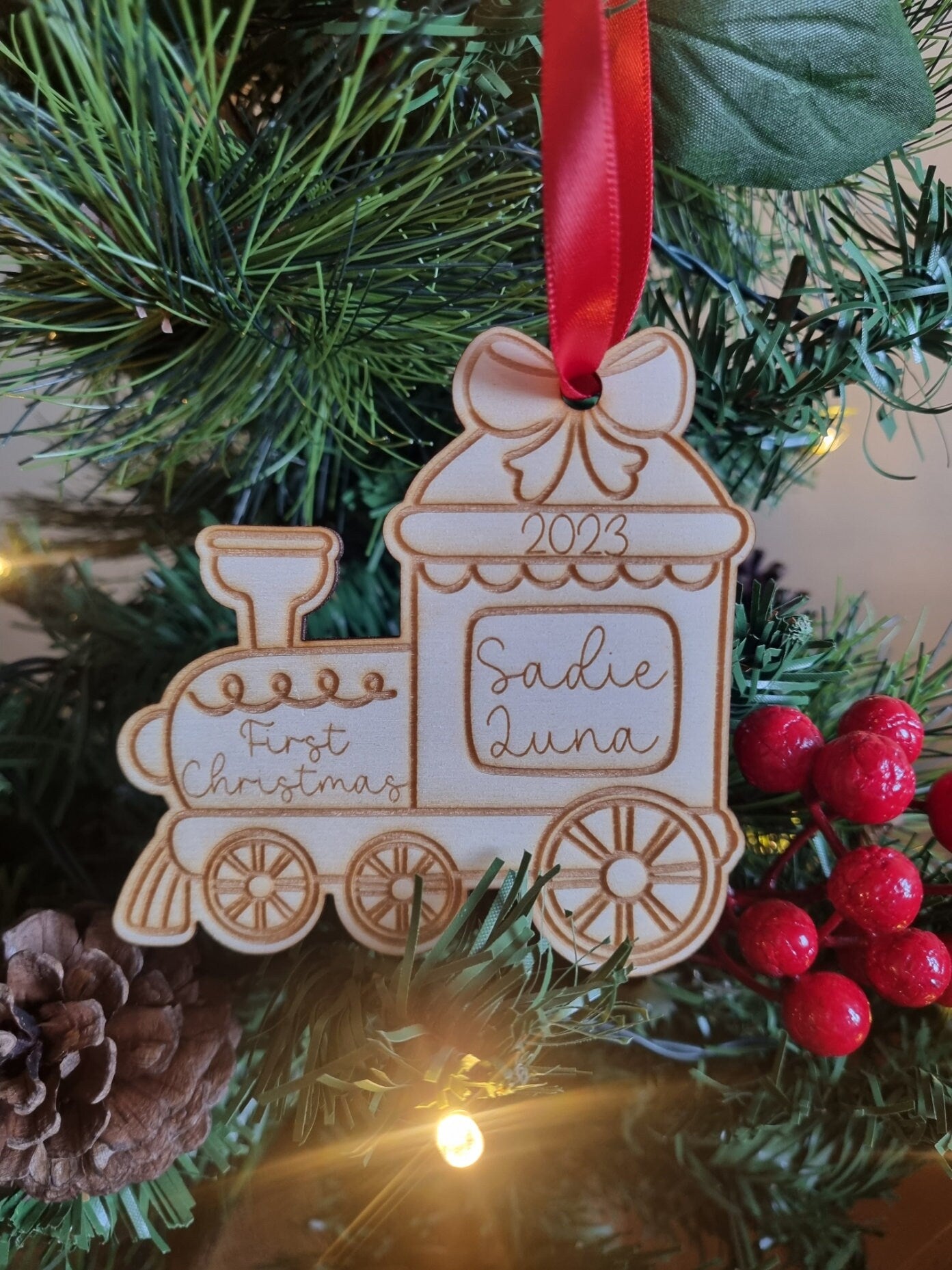 Personalised Christmas Tree Ornament made from poplar ply wood. It has been laser cut and engraved in the shape of a christmas train.