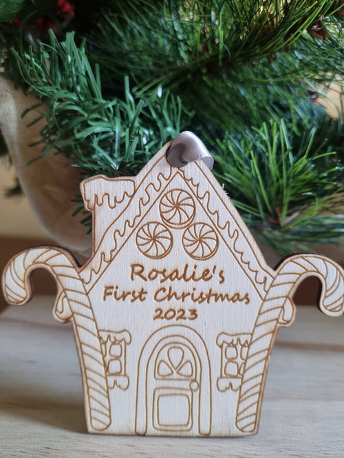 Personalised Christmas Tree Ornament made from poplar ply wood. It has been laser cut and engraved in the shape of a christmas gingerbread house and is hanging on a Christmas Tree.