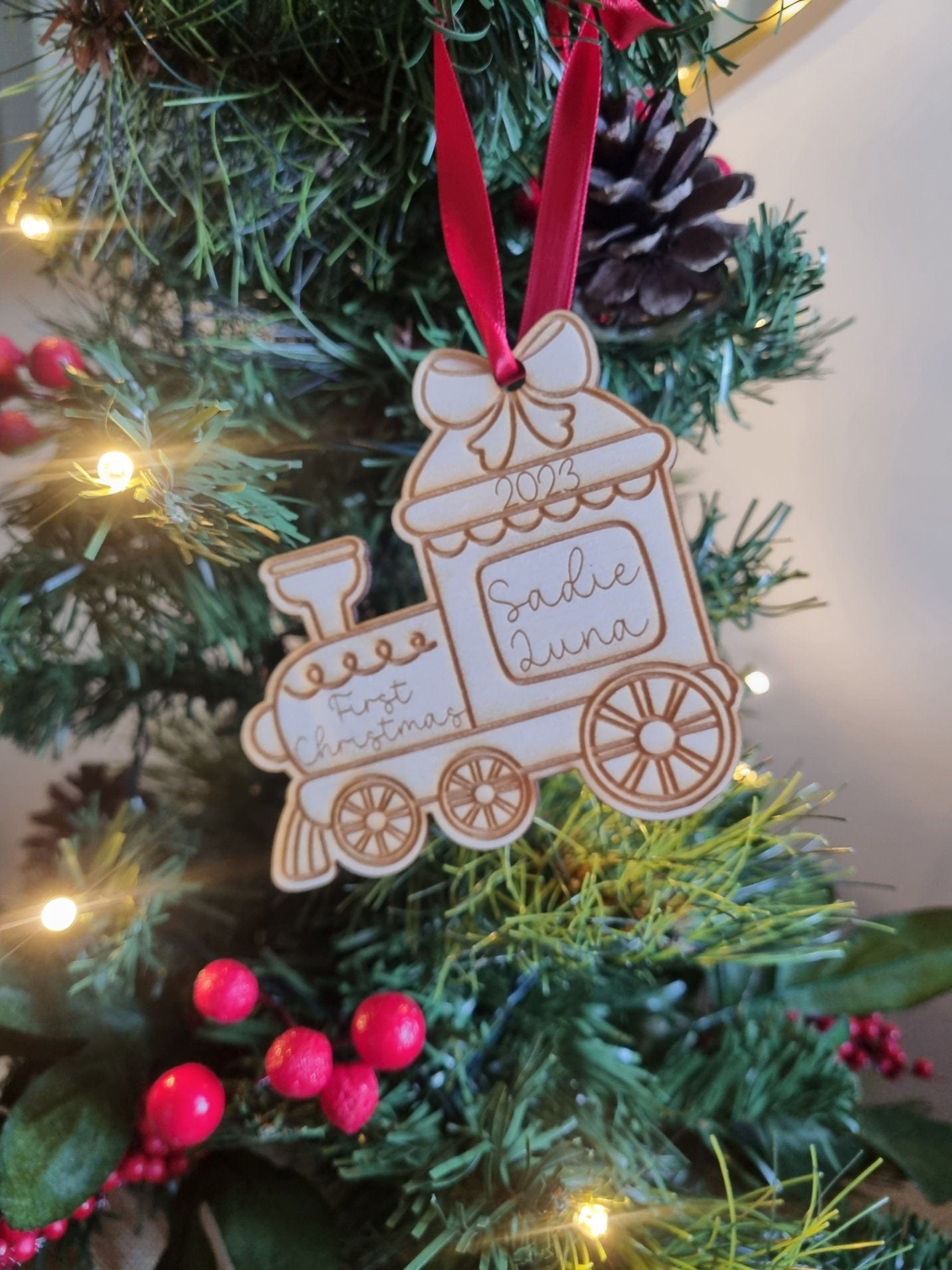 Personalised Christmas Tree Ornament made from poplar ply wood. It has been laser cut and engraved in the shape of a christmas train.