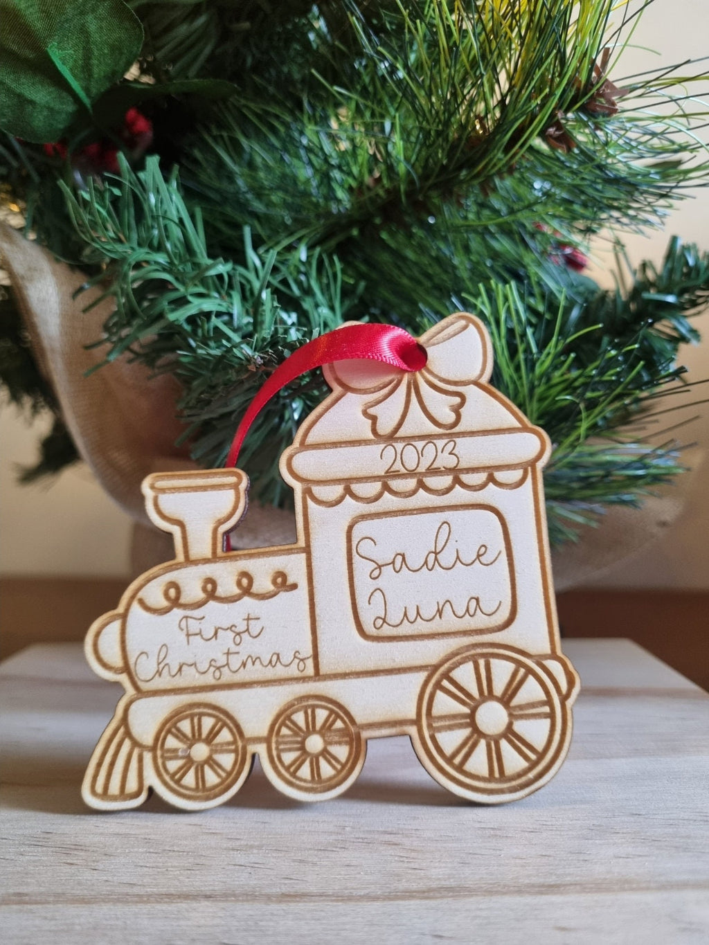 Personalised Christmas Tree Ornament made from poplar ply wood. It has been laser cut and engraved in the shape of a christmas train.
