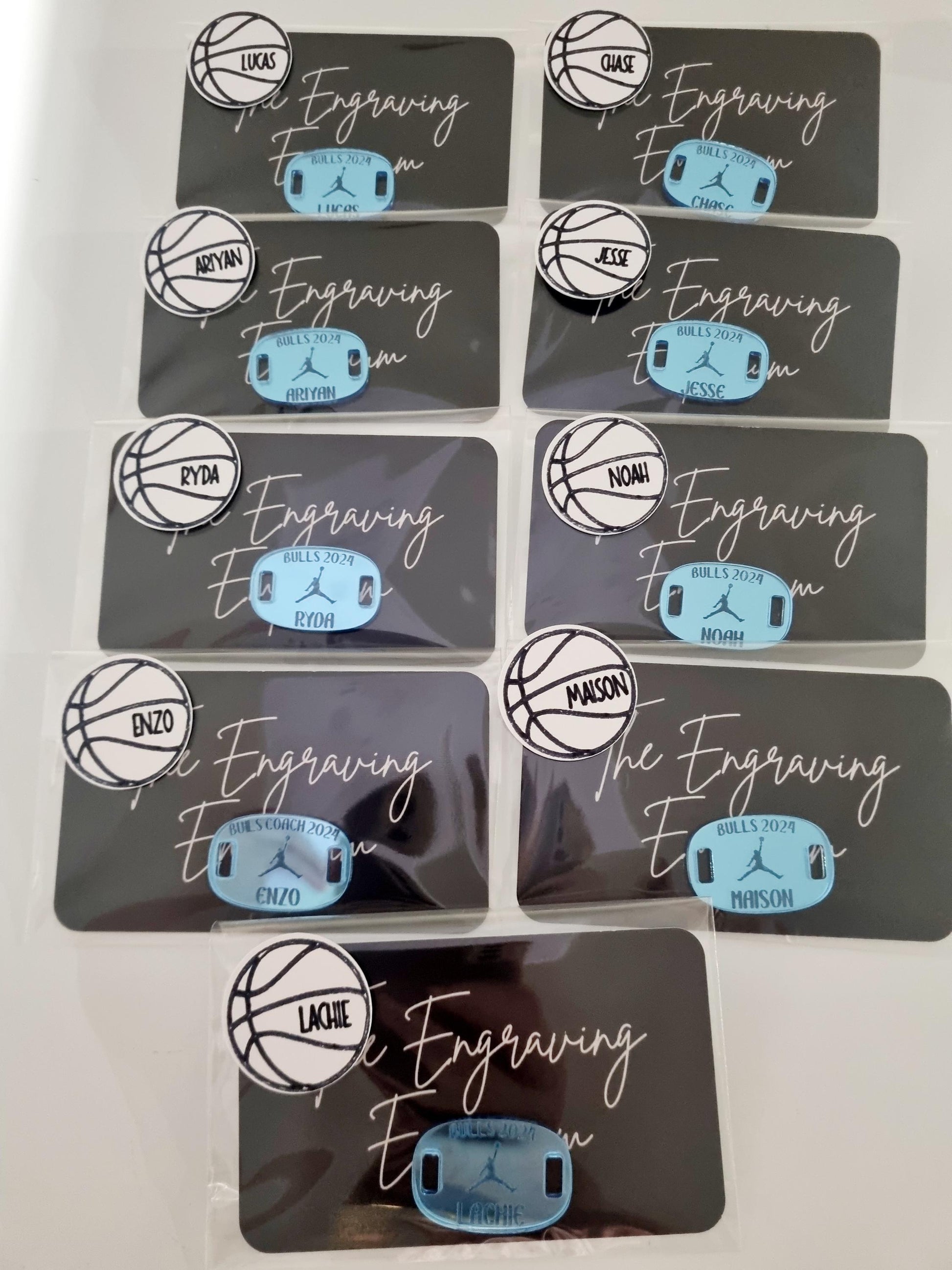 Individually packaged engraved shoe tags, made of baby blue mirrored acrylic, featuring player names and team name. A thoughtful and unique gift for a basketball team.